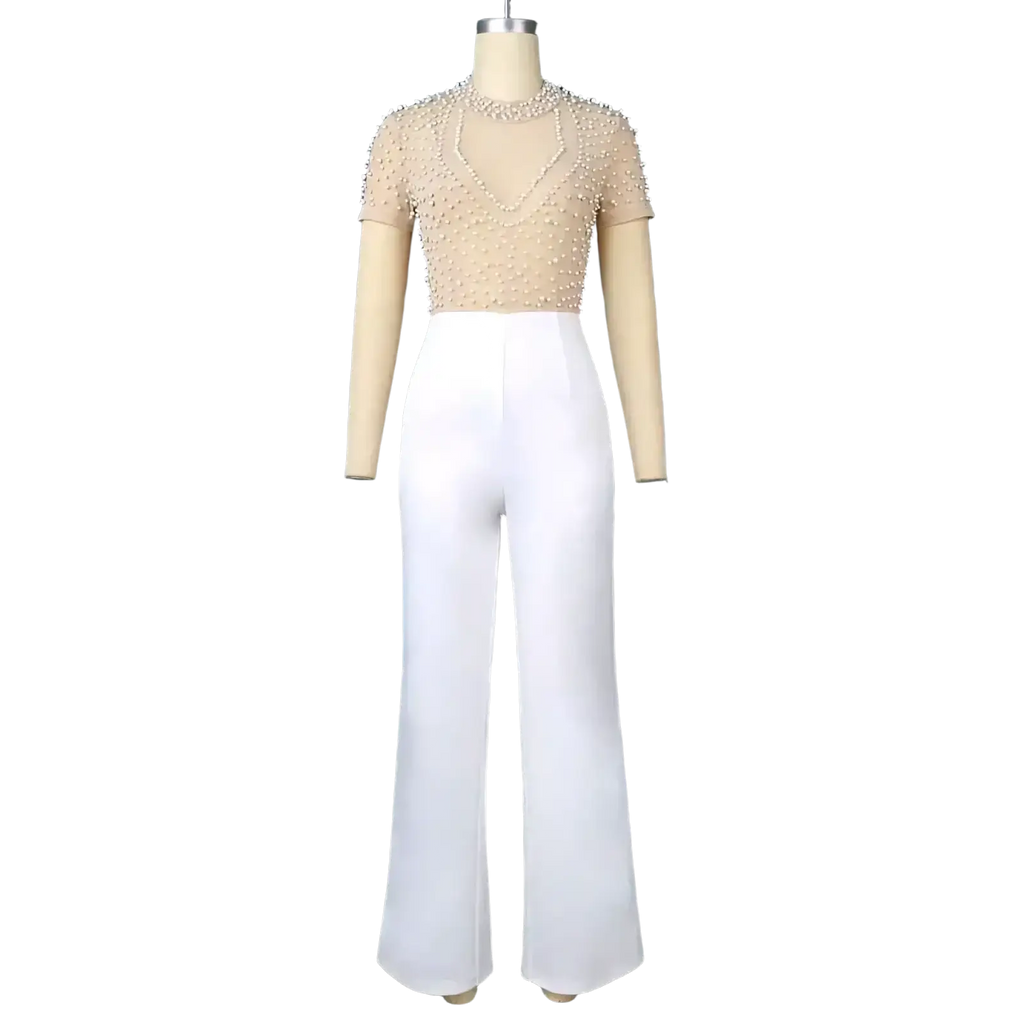 Beige beaded mesh top paired with high waist white wide leg trousers in a beige beaded mesh party outfit