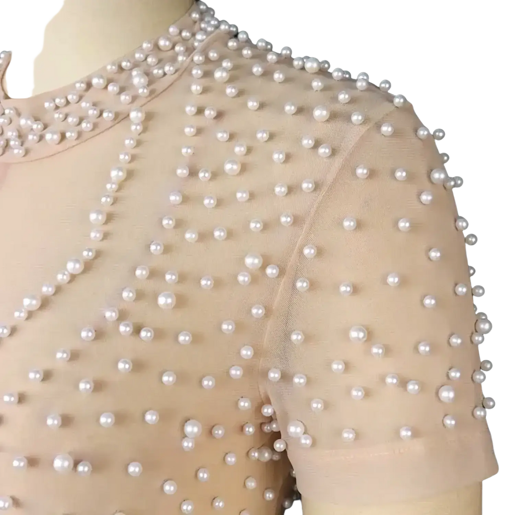 Beige beaded mesh jumpsuit featuring a delicate beige mesh top adorned with evenly spaced white pearls for parties
