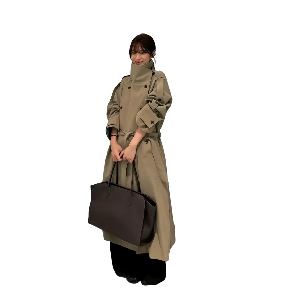 Beige belted trench coat for women with high collar and buttoned cuffs worn over black pants in tan material