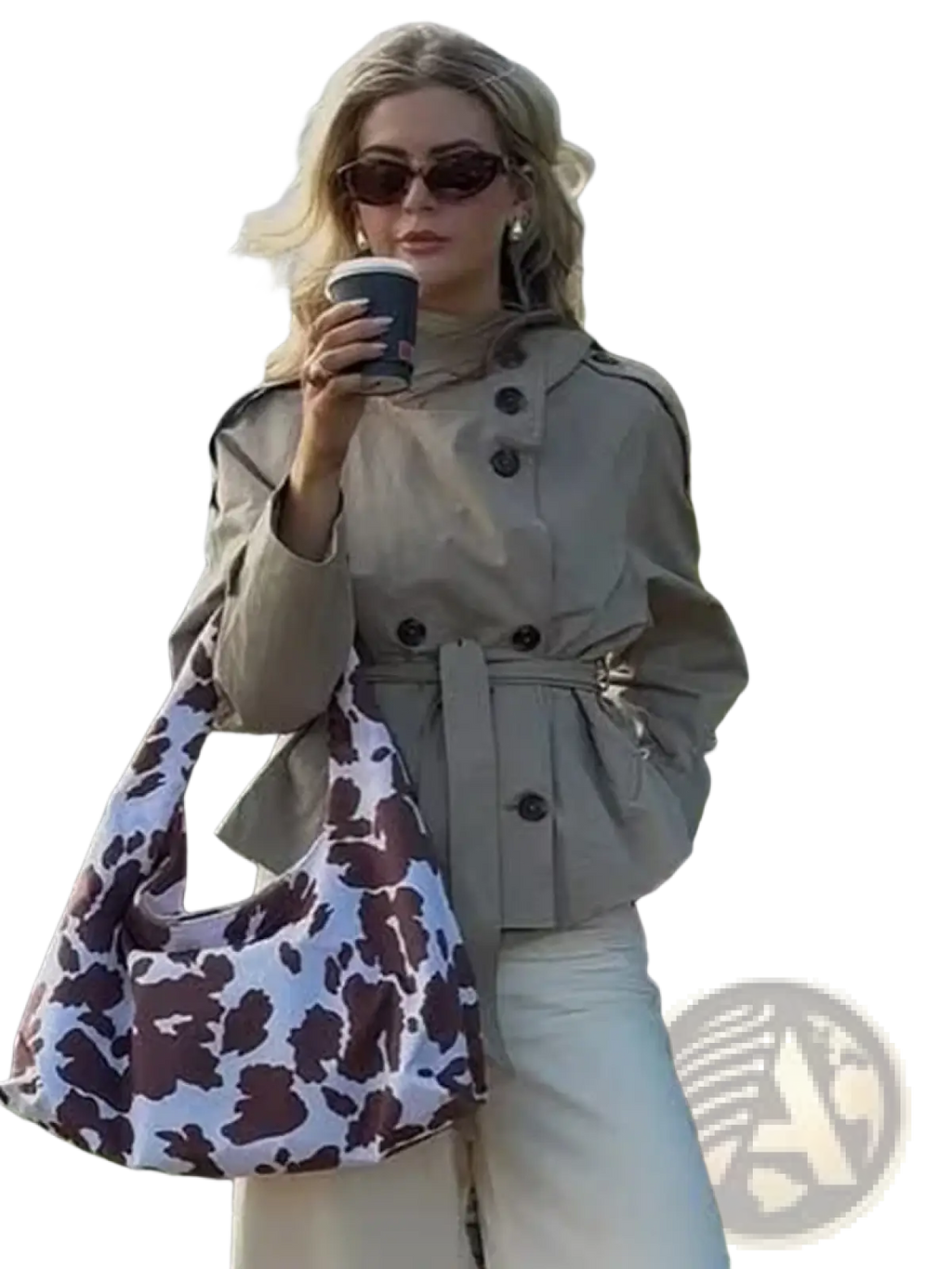 Beige double breasted trench coat paired with a white and brown cow print soft slouchy hobo bag