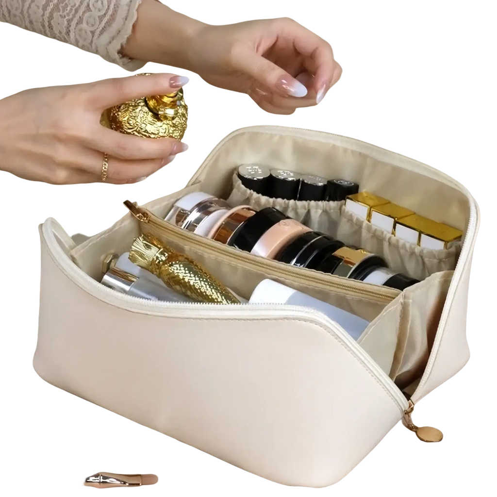Beige fabric travel makeup bag with internal compartments holding cosmetics and gold-toned decorative items