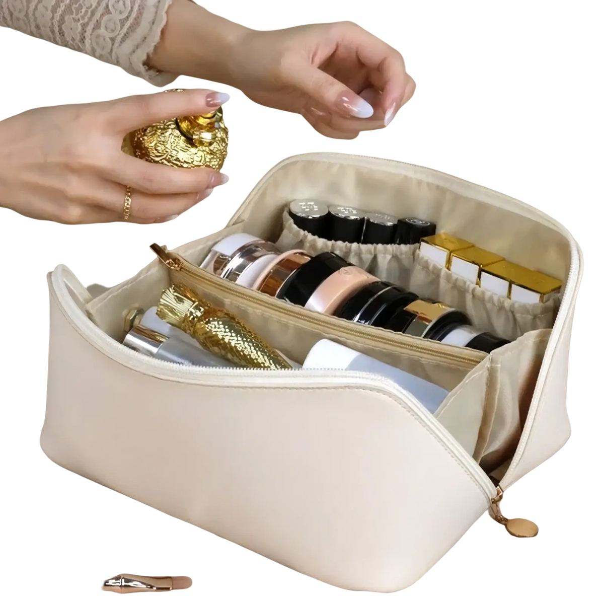 Beige fabric travel makeup bag with internal compartments holding cosmetics and gold-toned decorative items