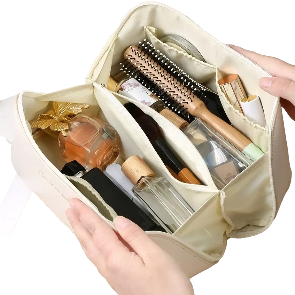 Beige fabric travel makeup bag and toiletry organizer with multiple compartments holding brushes bottles and cosmetics