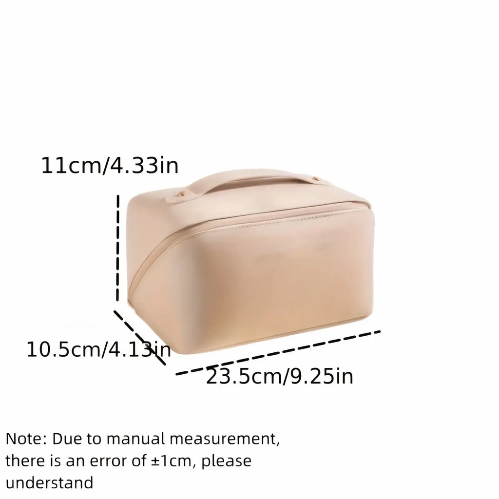 Beige fabric travel makeup bag with satin-finish, top handle, and zipper closure for toiletry organization