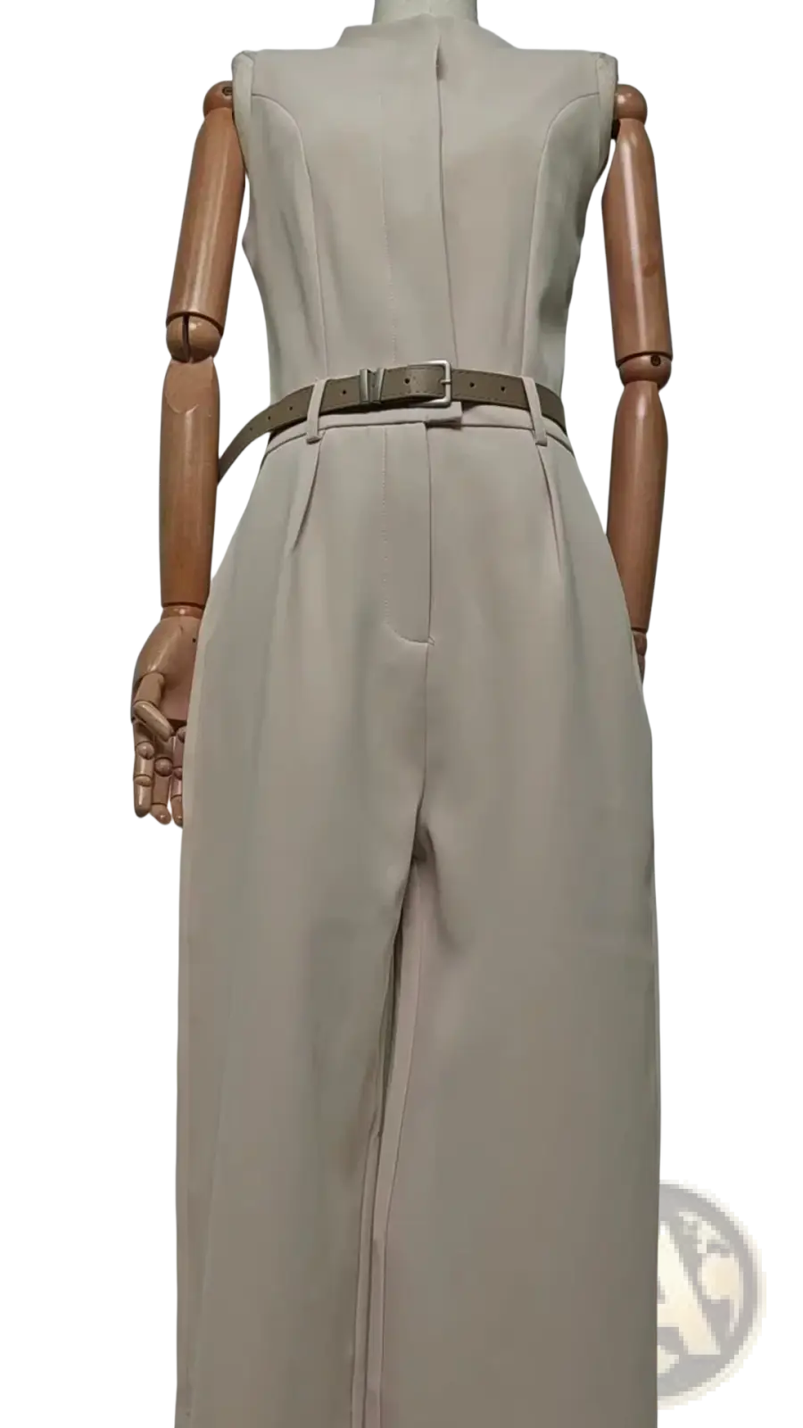 Beige halter neck wide leg jumpsuit with fitted waist and matching belt featuring high-waisted wide-leg pants