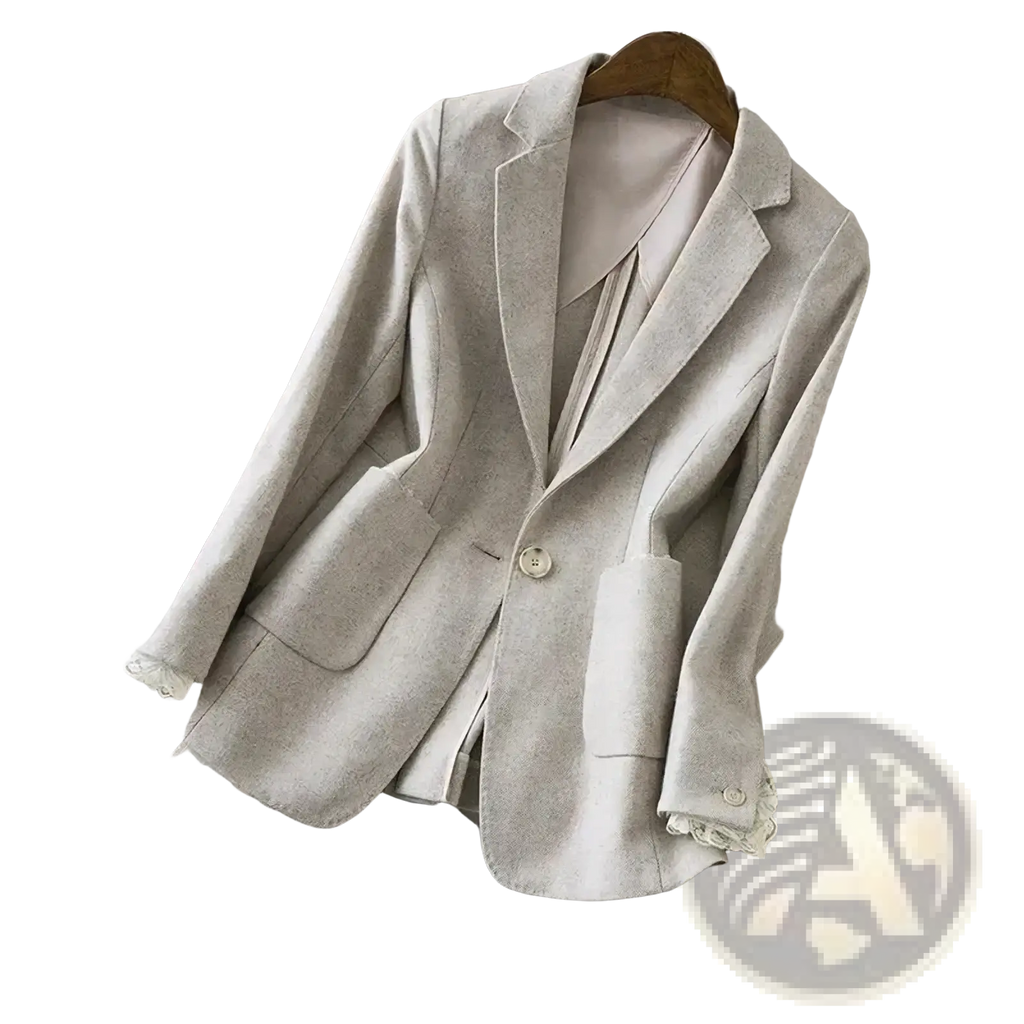 Beige wool blazer with delicate lace trim at cuffs and pocket edges hanging on a wooden hanger