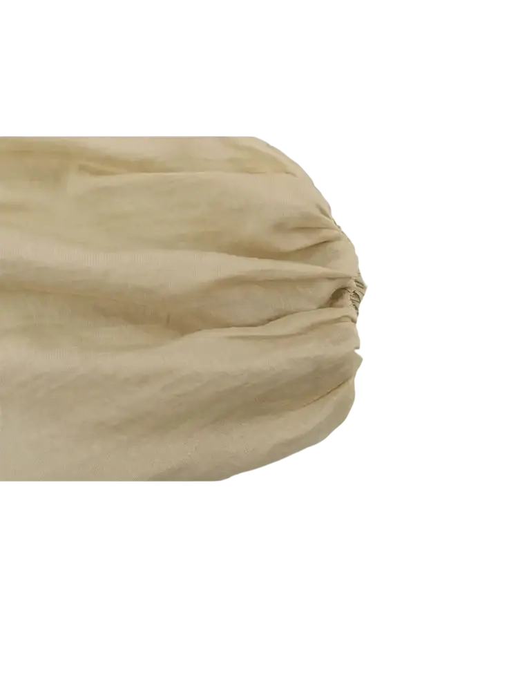 Beige puffed sleeve cropped corset top paired with beige linen bedsheet featuring a gathered elasticized edge