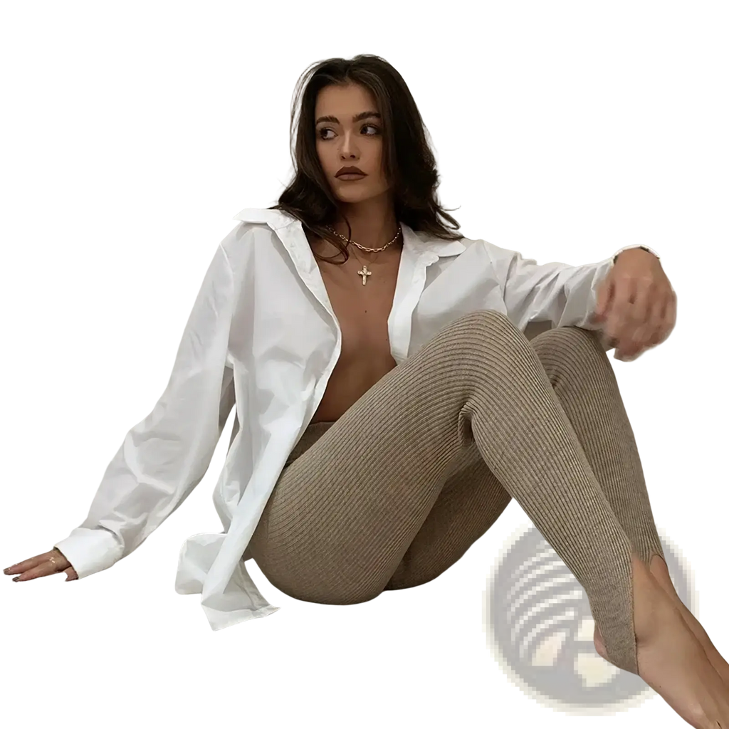 A woman wearing beige ribbed knit high waist leggings paired with a white button-up shirt