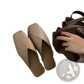 Beige square toe flat mules with a sleek minimalist design and soft leather finish