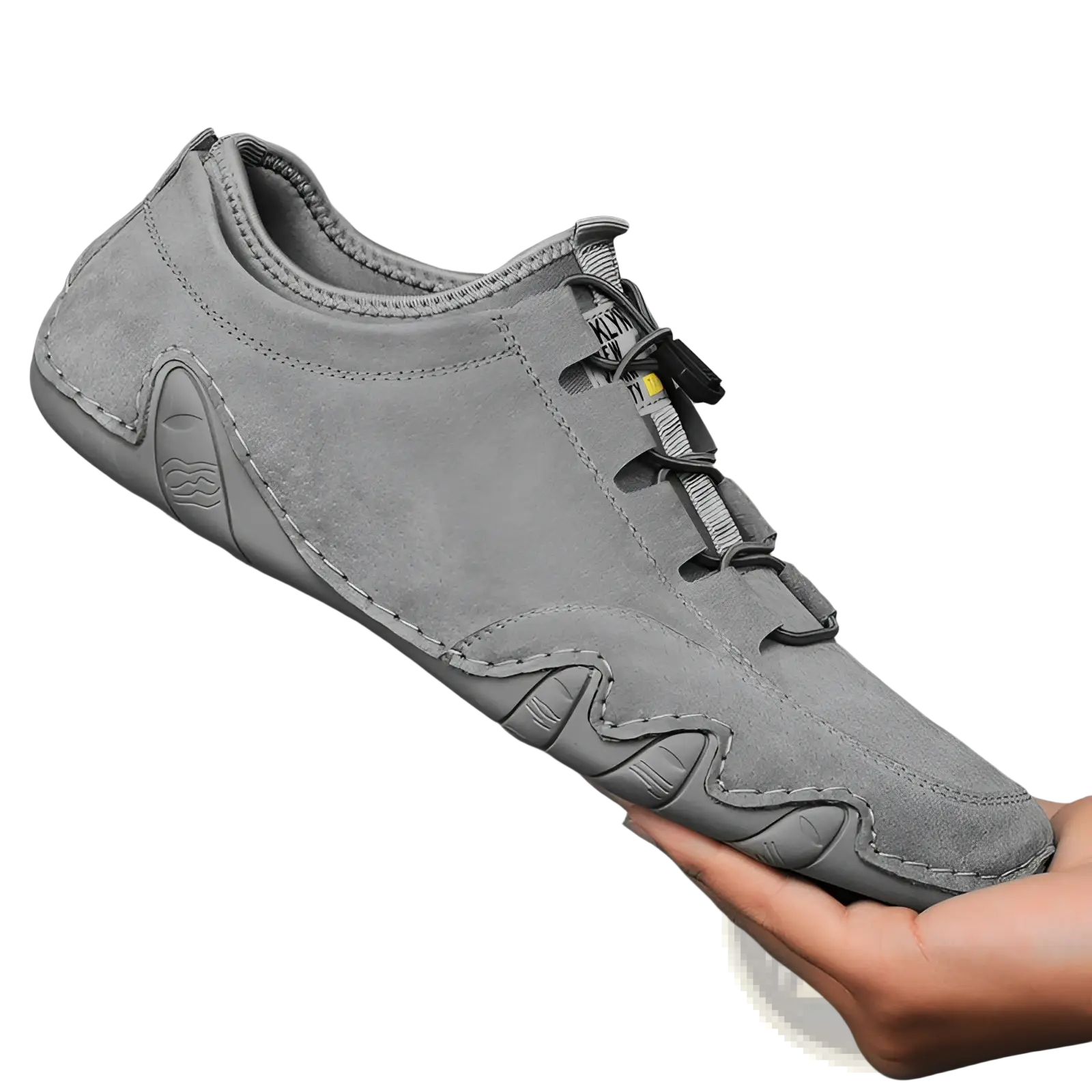 Beige suede leather men’s low top leisure shoe with gray suede slip-on design and textured wave-patterned rubber sole