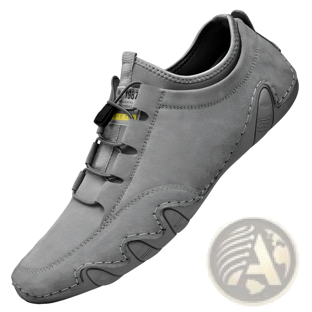 Beige suede leather men’s low top leisure shoe with gray suede upper and black laces featuring a sleek minimalist design
