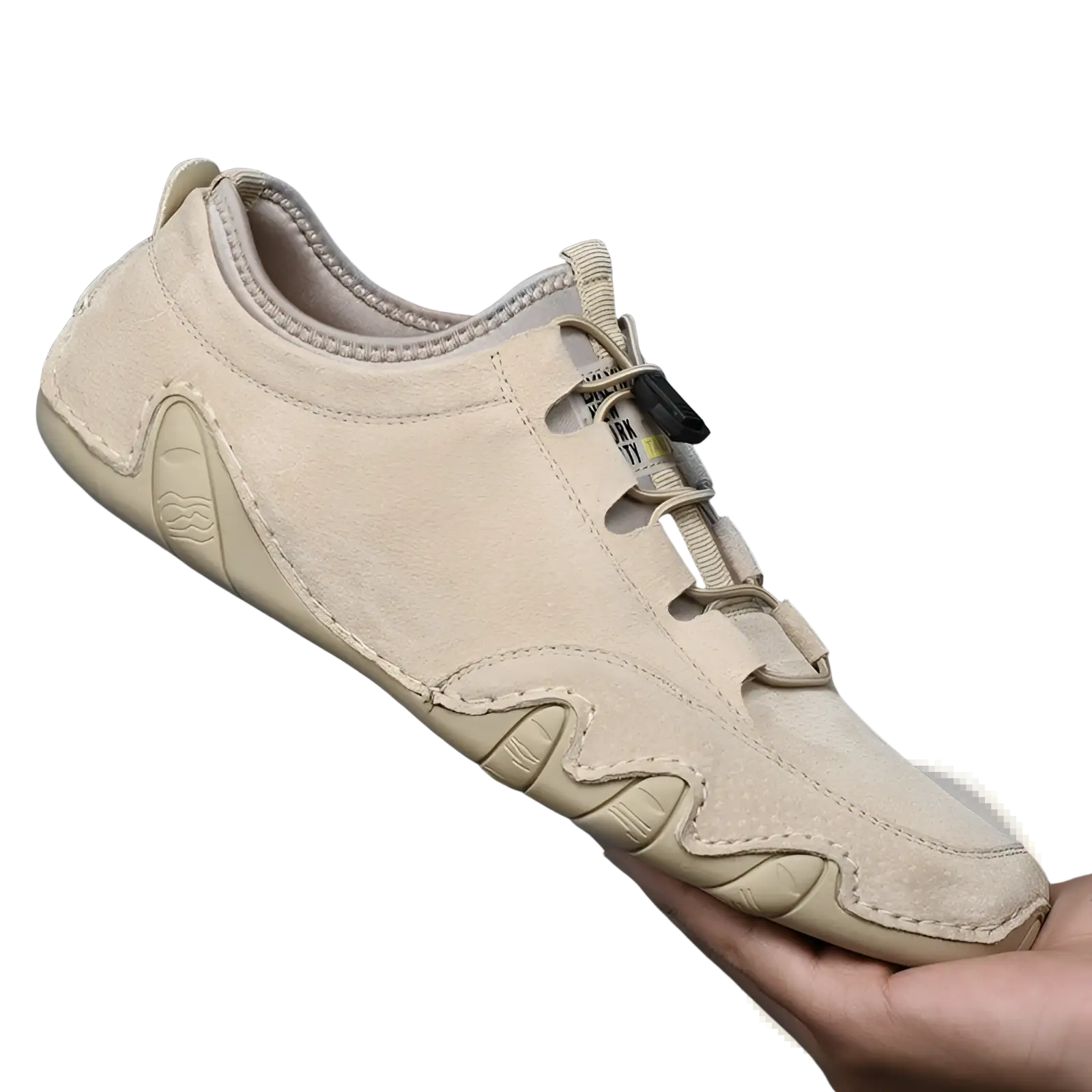 Beige suede leather men’s low top leisure shoe with slip-on design textured wave-patterned sole and adjustable strap closure