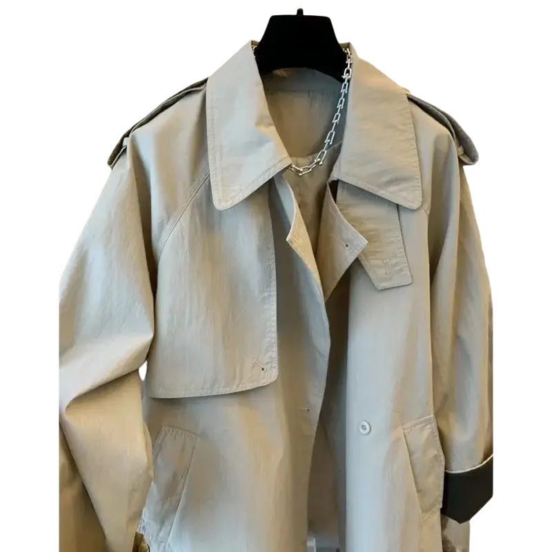 Beige trench coat autumn winter women outerwear with black trim on cuffs and collar and classic double-breasted design
