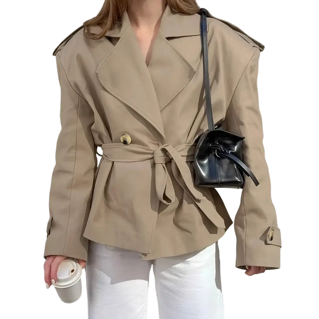 Beige trench coat with belted waist gold-toned buttons and structured shoulders in a classic design