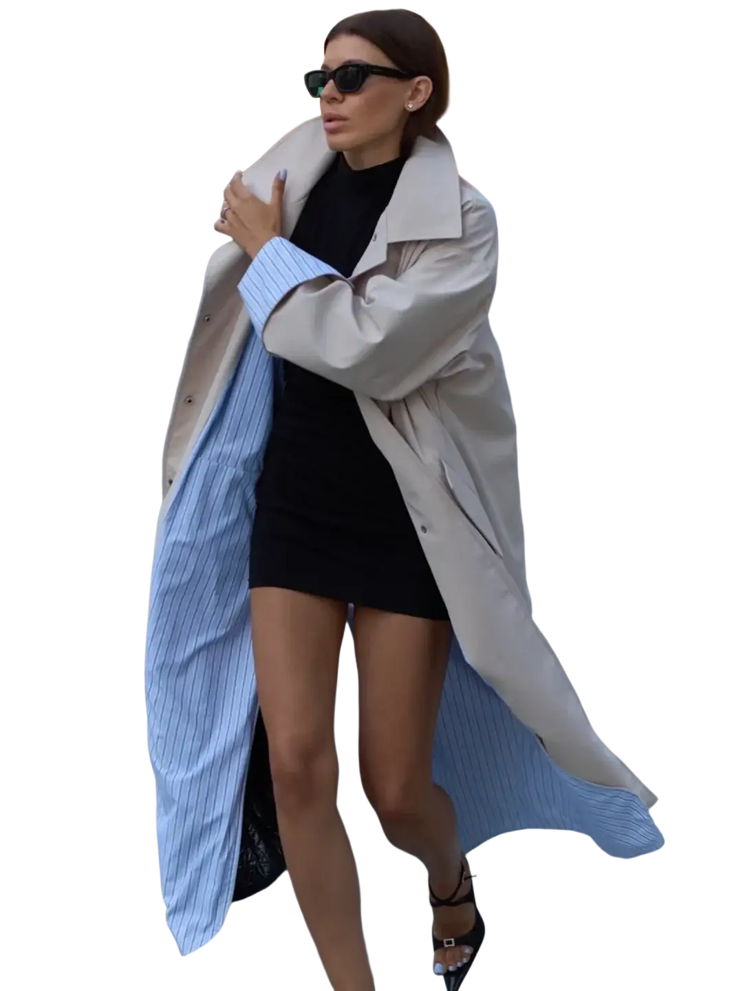 Beige trench coat with elegant light blue pinstriped lining worn open over a black dress for stylish outerwear