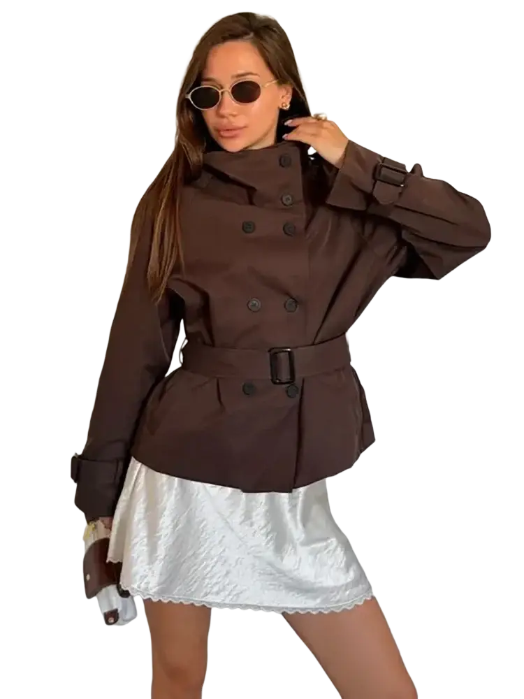 Brown vintage double breasted trench coat with black buttons and belted waist for women in a classic design