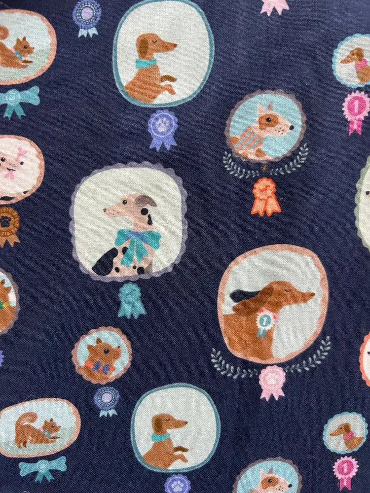 Navy blue best in show dog print pleated skater skirt featuring cartoon dogs and cats in oval frames with ribbons