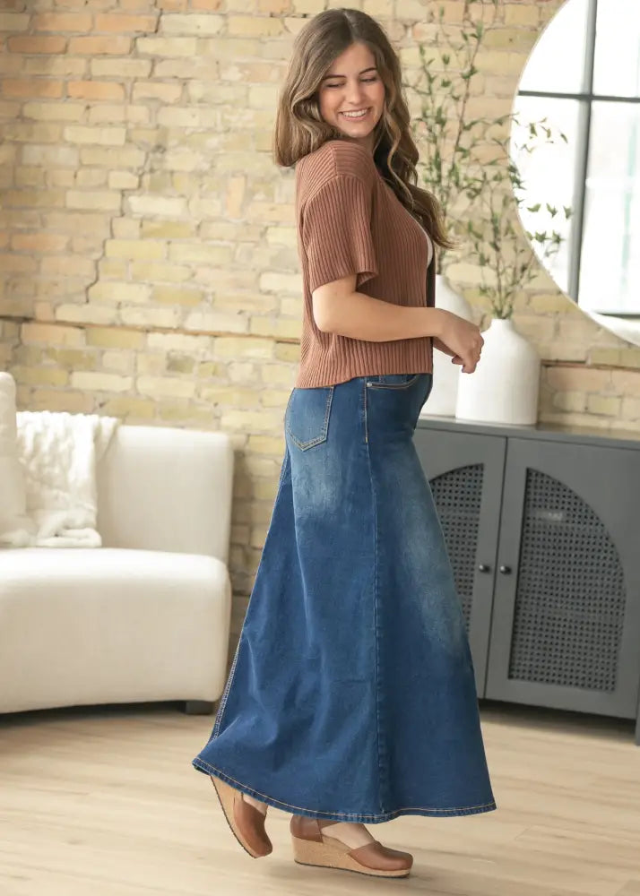 Bethany dark wash a-line denim maxi skirt with a flowing blue fabric, classic waistband, and visible hem stitching