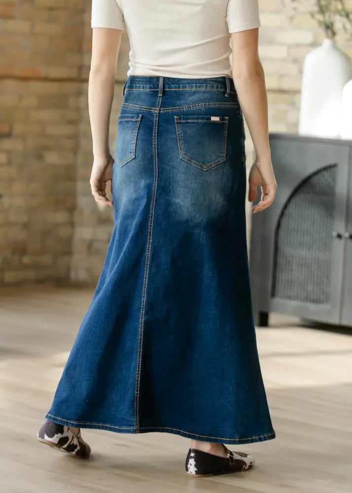 Bethany dark wash a-line denim maxi skirt in deep blue with classic back pocket design and subtle fading shown from back side