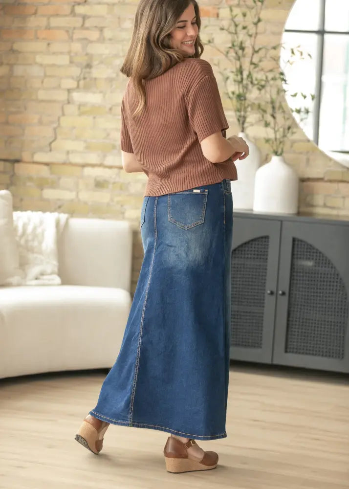 Bethany dark wash a-line denim maxi skirt in medium blue wash with visible stitching and back pockets shown from the back