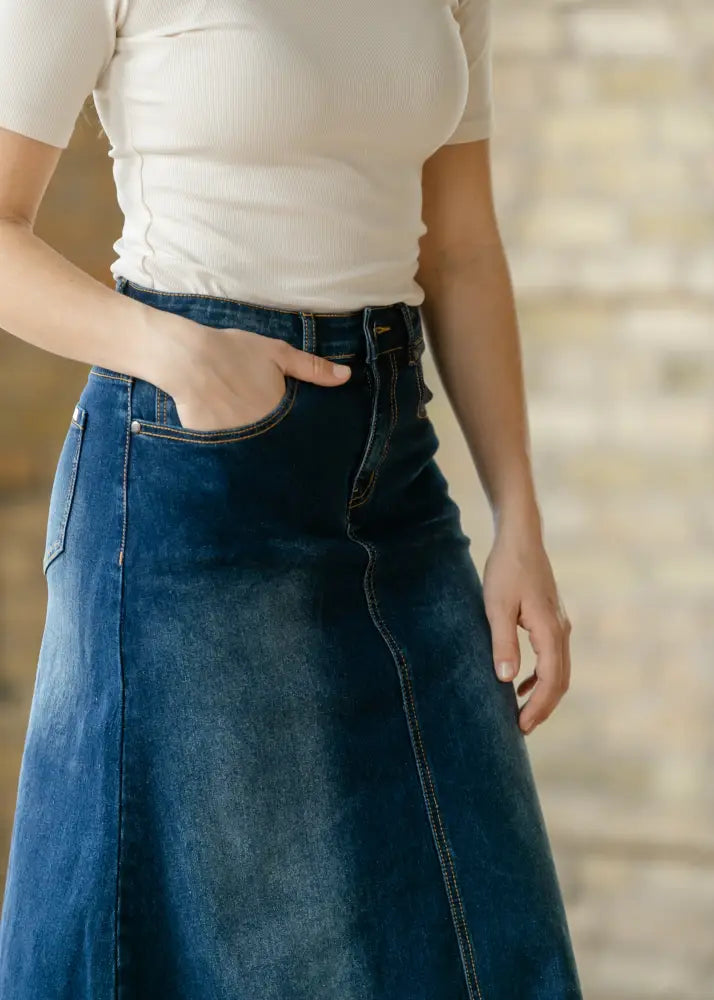 Bethany dark wash a-line denim maxi skirt featuring high waist, dark blue material, straight cut, and front pockets