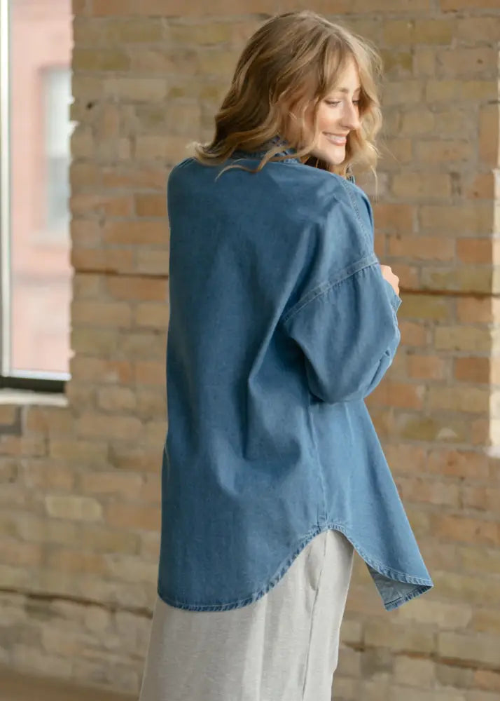 A soft blue denim Betty denim relaxed button up shirt with oversized fit and slightly flared sleeves