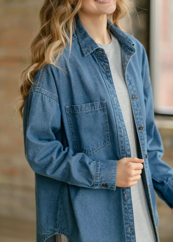 Betty denim relaxed button up shirt in medium-wash denim with classic button front chest pocket and long sleeves
