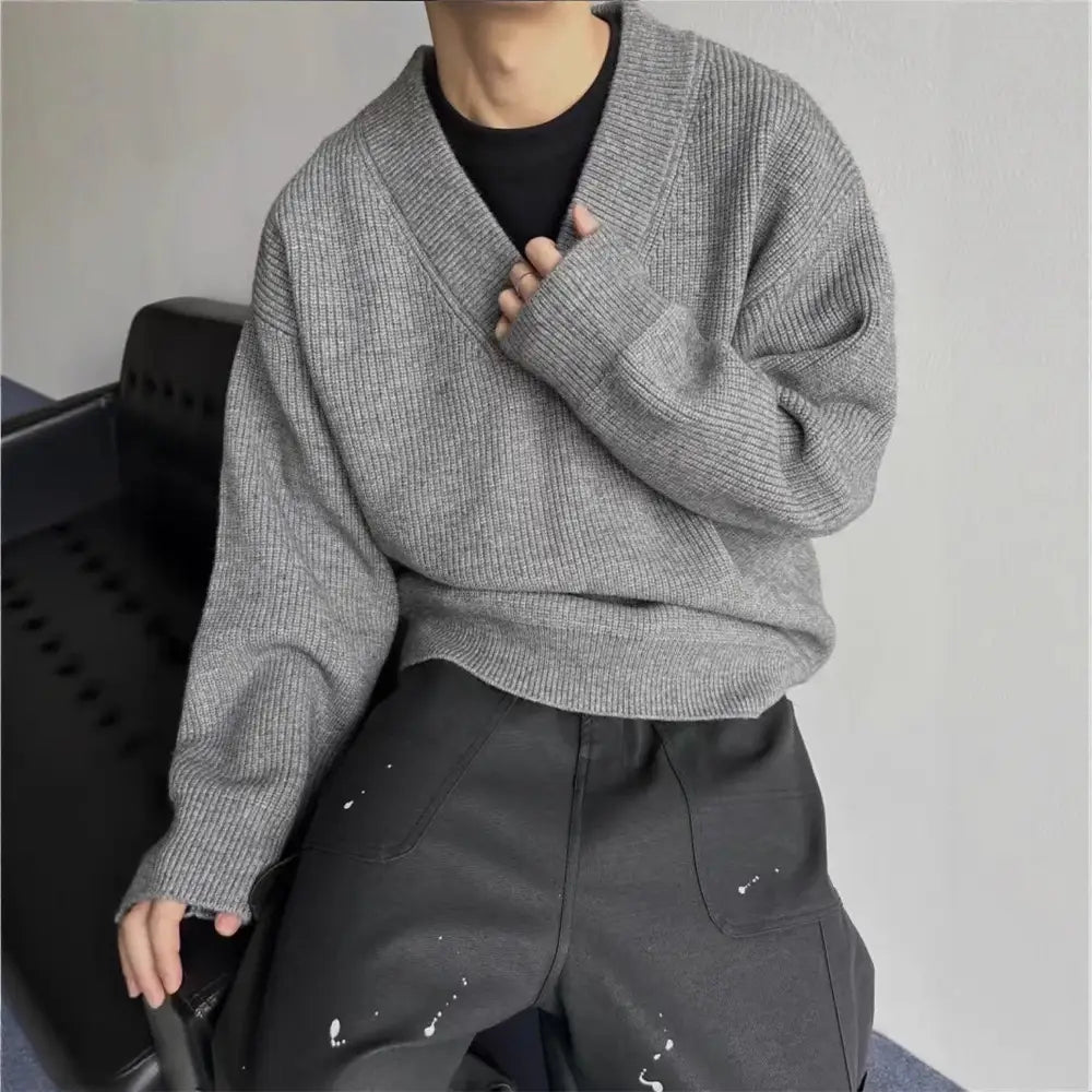 Gray ribbed knit v-neck sweater made of soft material designed for a relaxed fit and casual wear.