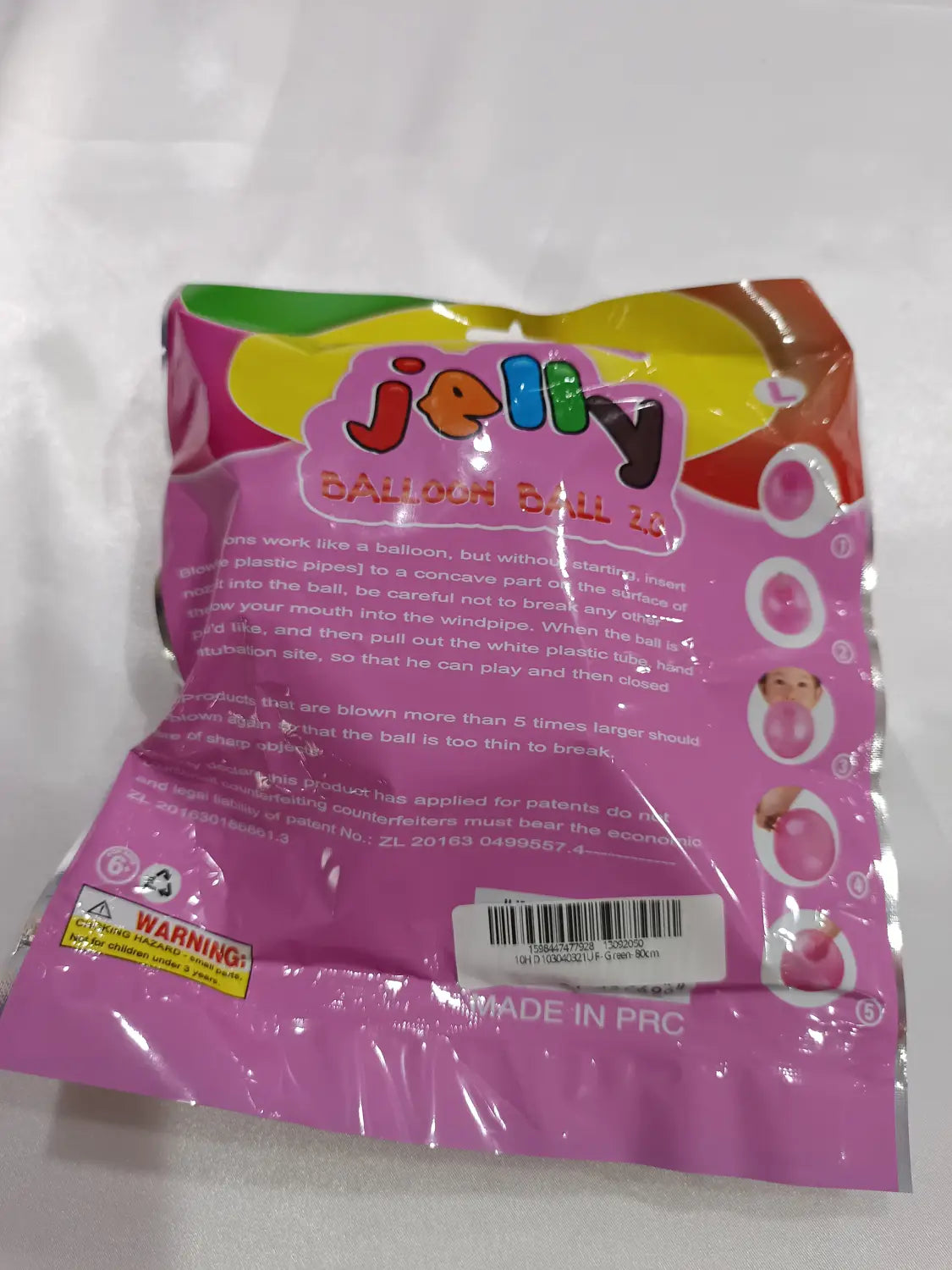 Una bolsa de plástico rosa que contiene un juguete gigante de globo de burbuja hinchable de TPR, tipo globo de agua elástico.