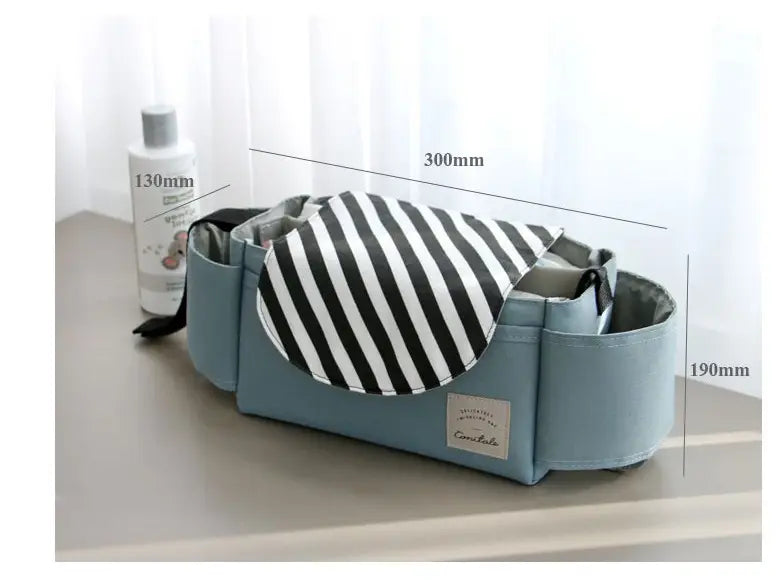 Light blue fabric stroller organizer bag with black and white striped interior lining featuring multi storage pockets.