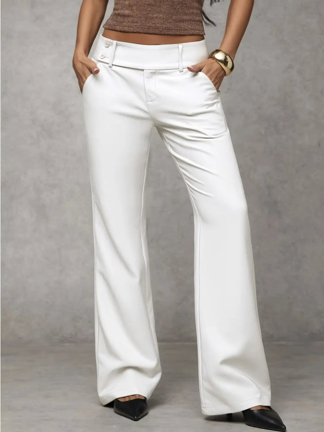 White wide leg work pants with a high waist and buttoned belt loops designed as casual trousers.