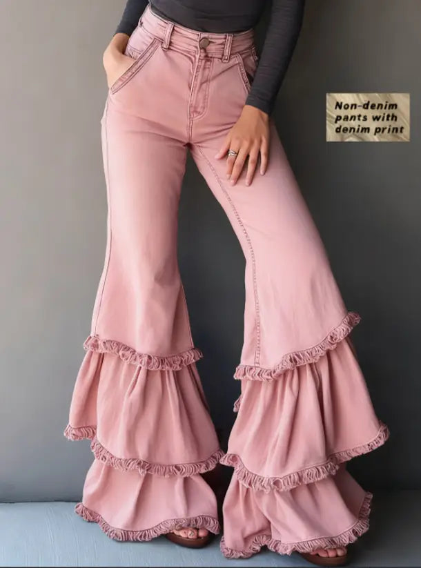 Denim print ruffled flared pants in pink featuring layered ruffle detailing at the hem.