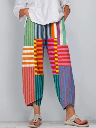 Artistic printed and embroidered slimming cropped pants featuring colorful patchwork with vertical striped patterns in multiple hues.
