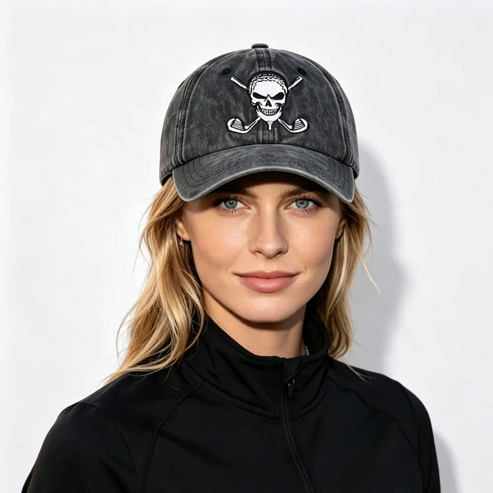 A dark gray distressed baseball cap featuring a white embroidered skull and crossed golf clubs design in a vintage style golf hat.