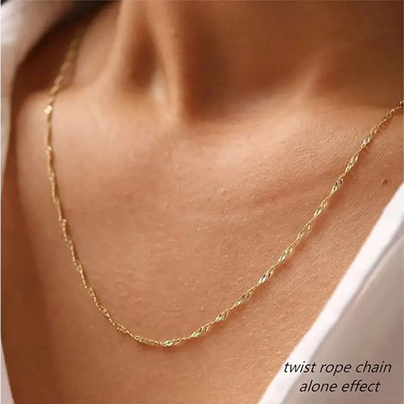 A delicate 14k gold plated dainty diamond solitaire pendant necklace featuring a gold twist rope chain with a subtle elegant texture.