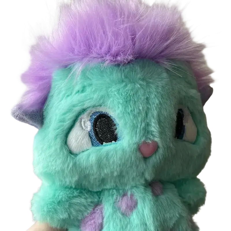 A plush turquoise bibble plush toy with spiky purple fur embroidered blue eyes and a pink nose cute stuffed anime doll