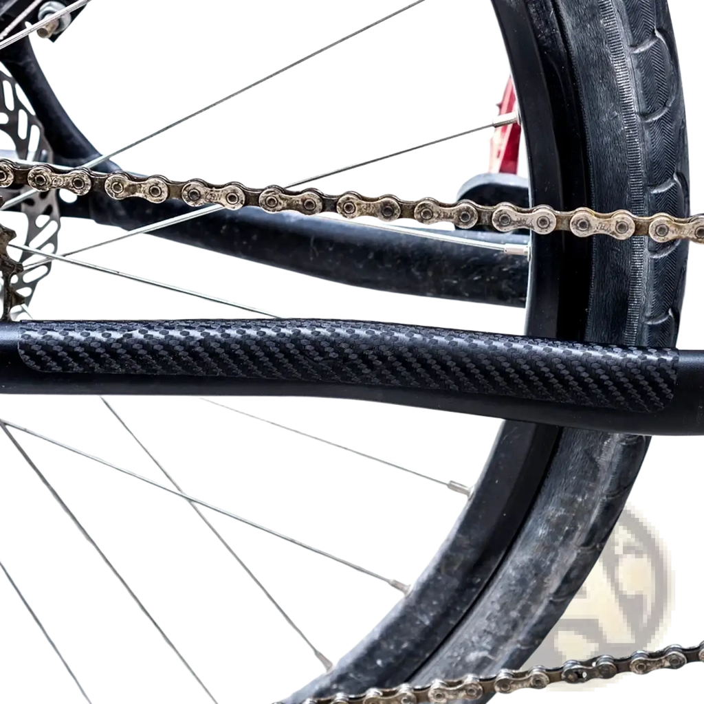 Black pvc bike chain protector with carbon fiber textured guard shown from the back side