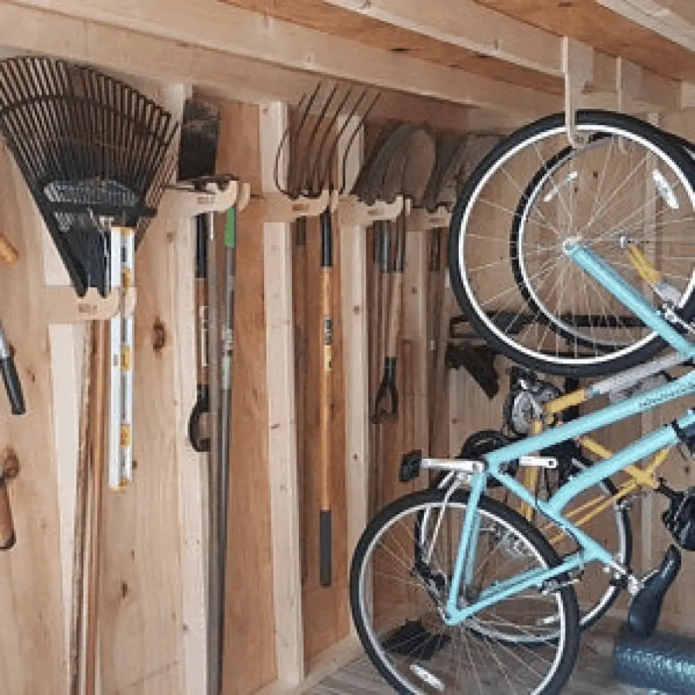 Heavy duty ceiling mount vertical bicycle storage hooks holding a light blue bicycle with black tires and silver spokes