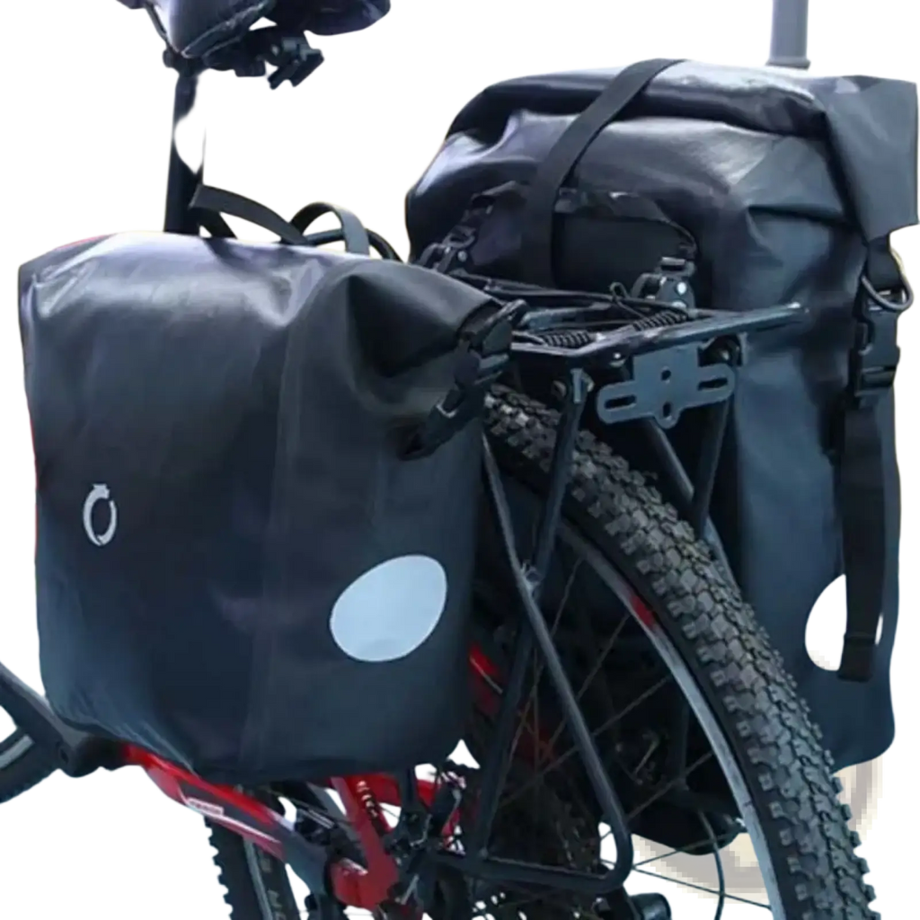 Black waterproof bike panniers with white circular reflective patches featuring mounting buckles and carrier straps