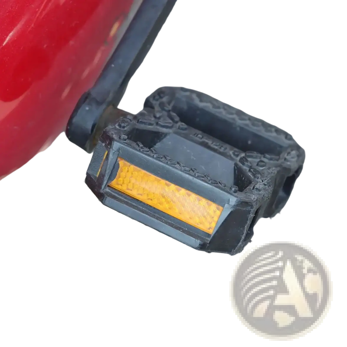 Black bike pedal with built-in amber reflector for safety in a four-pack reflector set, shown from the back side