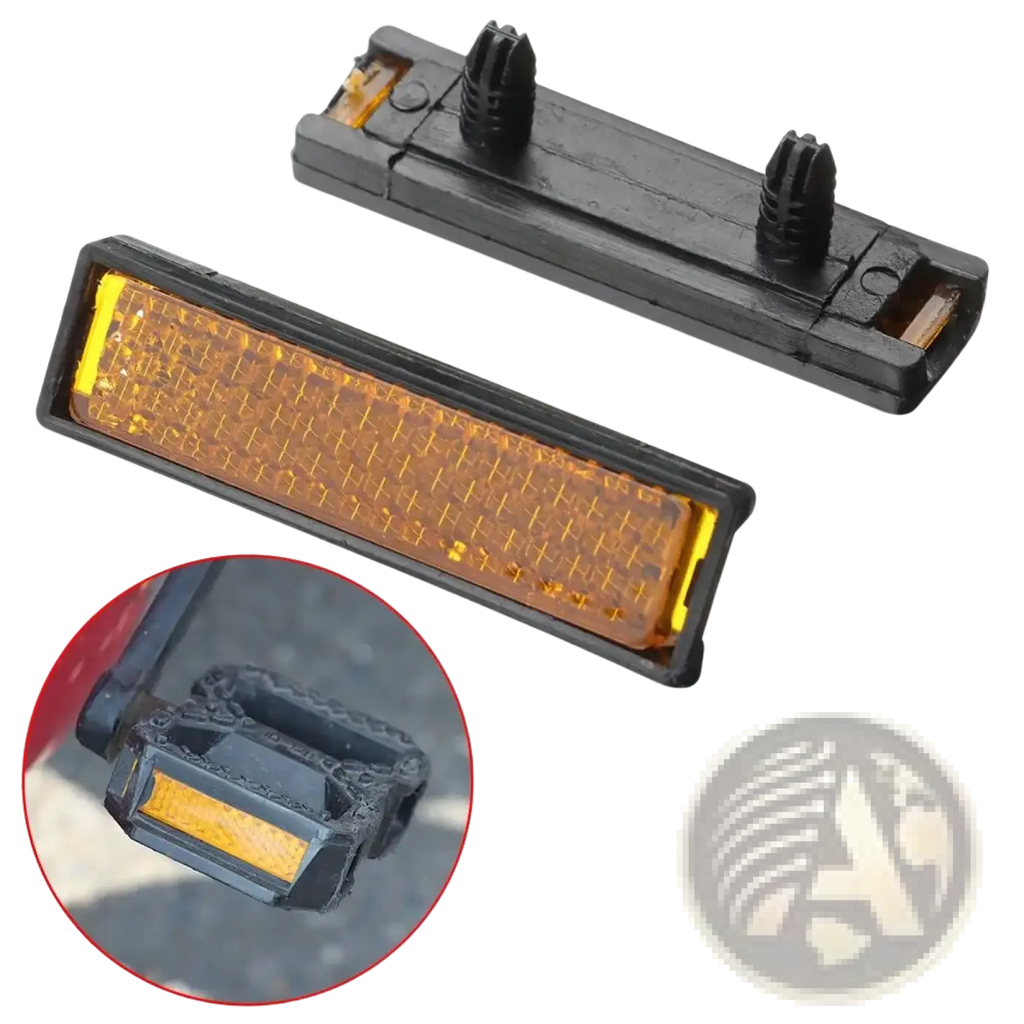 Black plastic bike pedal reflector with amber textured lens and two mounting tabs for safety visibility