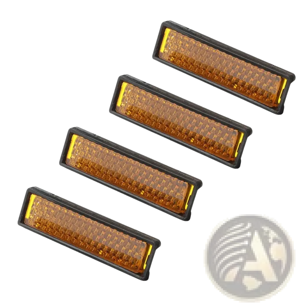 Set of four amber rectangular bike pedal reflectors with black plastic frames and textured surfaces for safety use