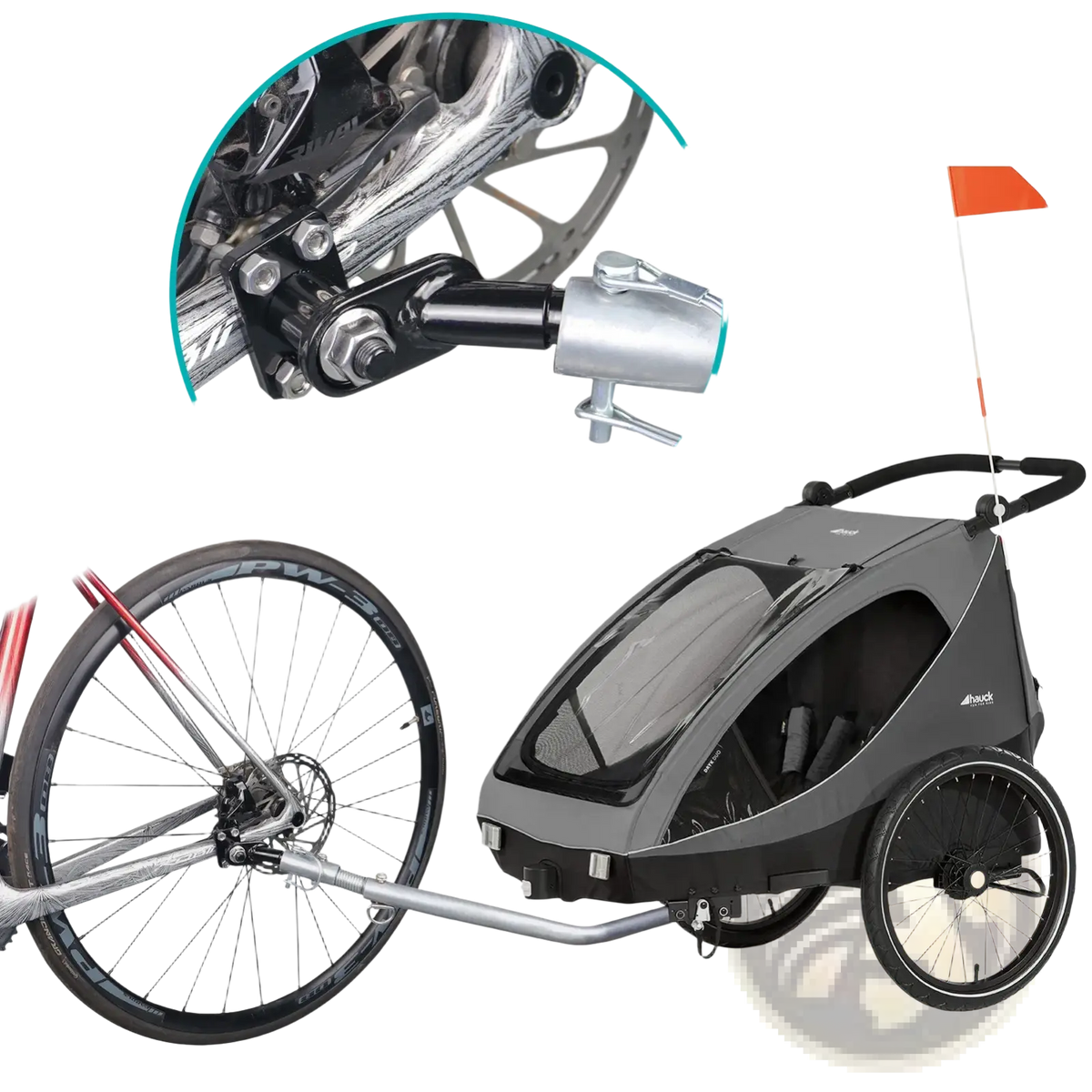 Gray and black child bike trailer with transparent front window attached to bicycle via silver metal hitch coupler adapter