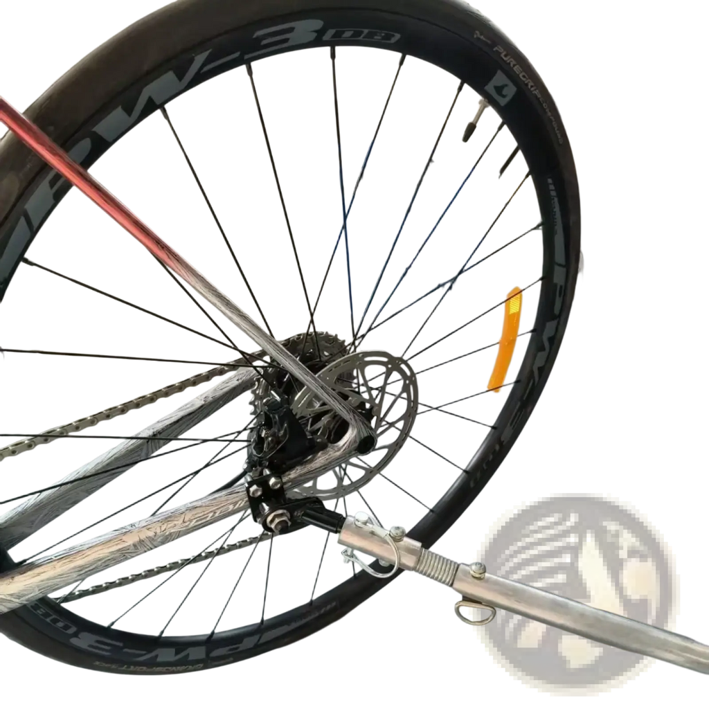 Silver metallic bike trailer hitch coupler with black tire and visible pw-3 08 rim spokes for bicycle connector adapter