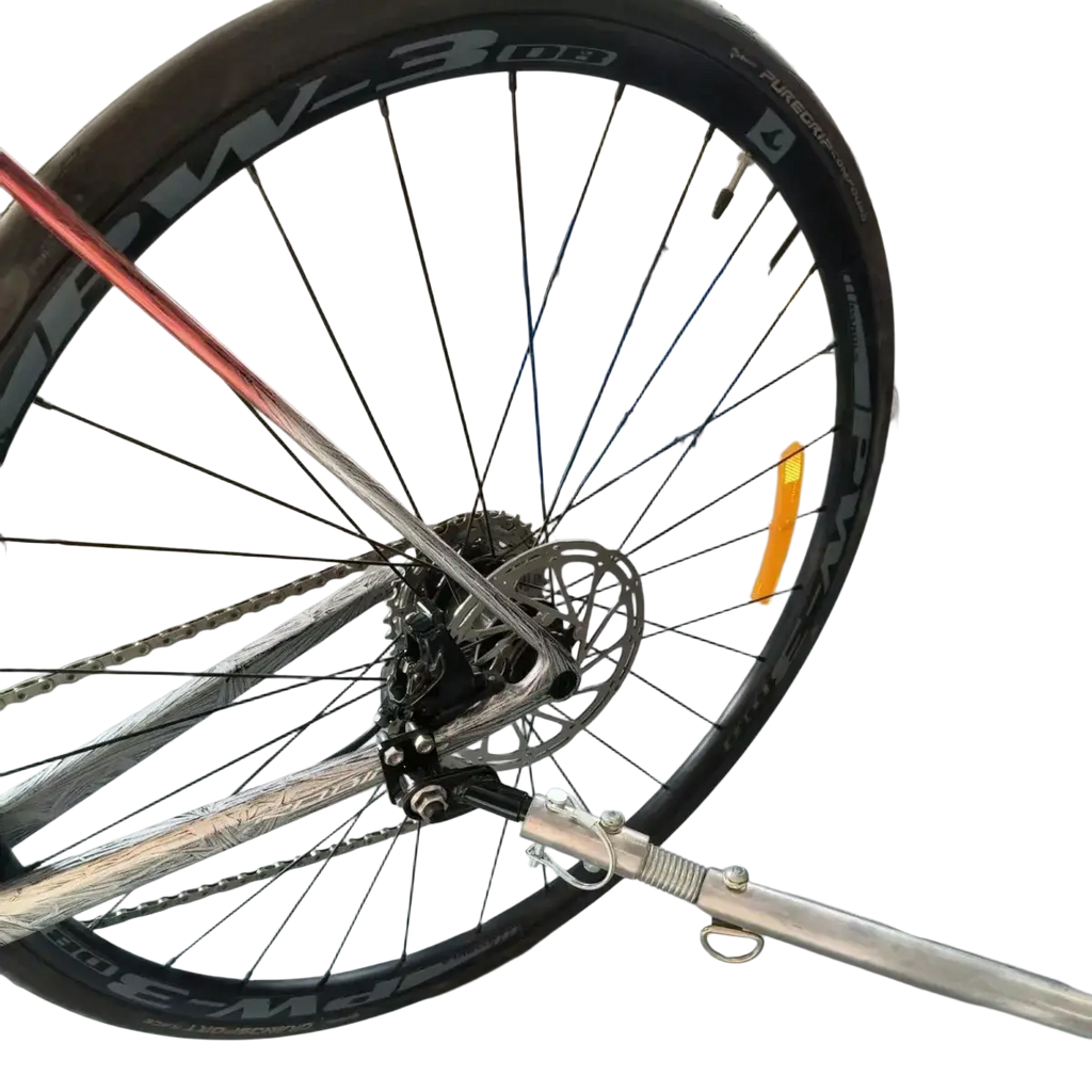 Silver metallic bike trailer hitch coupler with black tire and visible pw-3 08 rim spokes for bicycle connector adapter