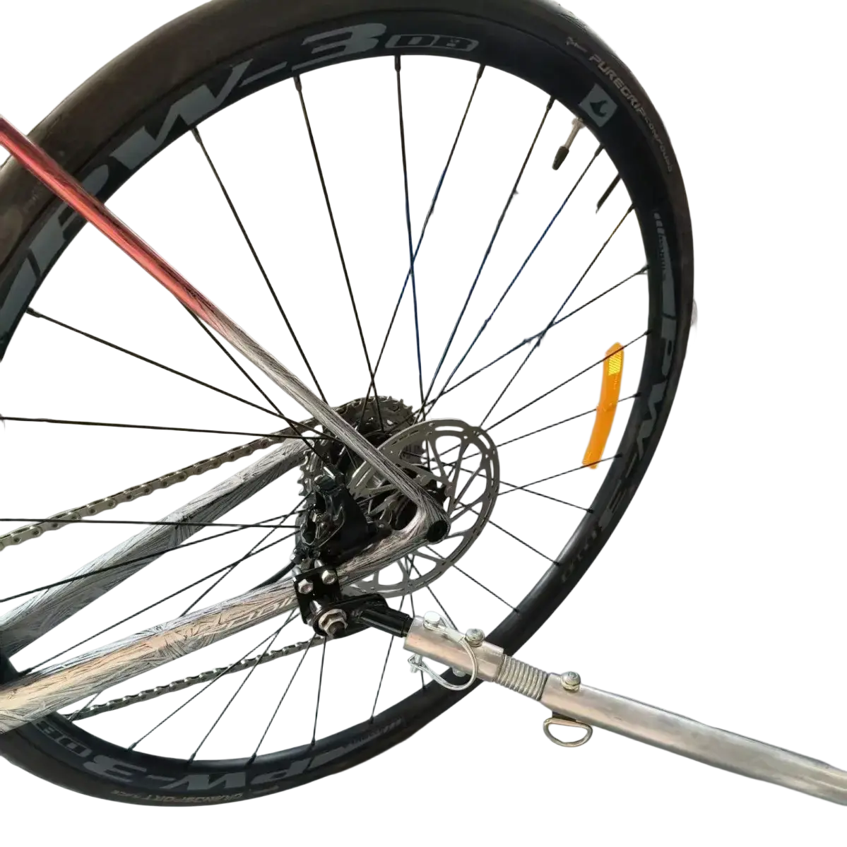 Silver metallic bike trailer hitch coupler with black tire and visible pw-3 08 rim spokes for bicycle connector adapter