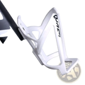 White plastic bike water bottle cage lightweight holder with black quan branding visible from the front side