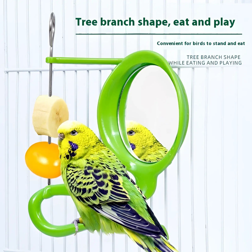 Bright green plastic bird feeder shaped like a tree branch with mirror and hanging food pieces for parrots