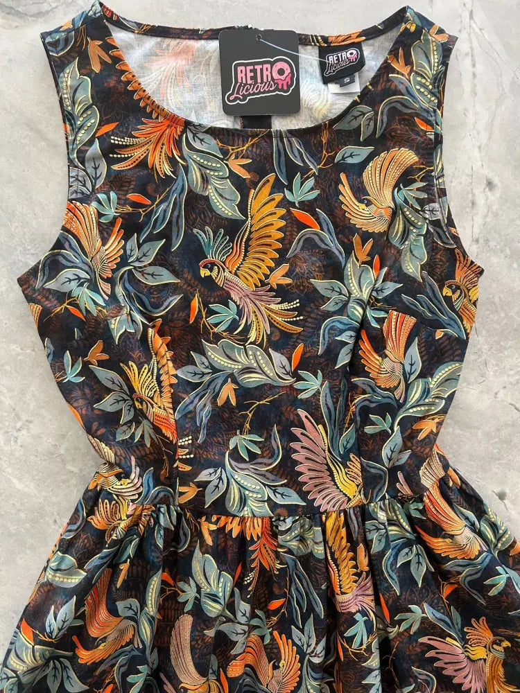 Birds of a feather vintage 1950s cotton midi sleeveless dress with vibrant tropical bird and leaf pattern on dark background