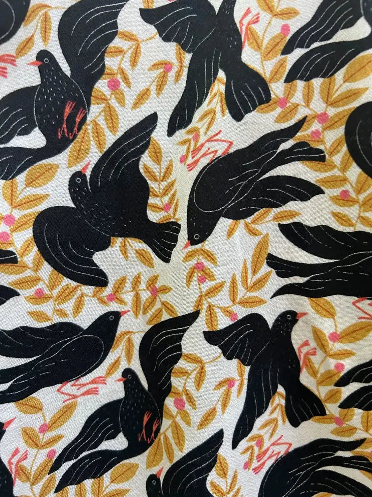 Vintage bird print cotton skater skirt with black birds red beaks white outlines on cream background with gold leaves and pink berries